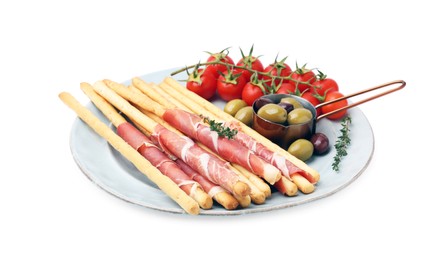 Photo of Plate of delicious grissini sticks with prosciutto, tomatoes and olives on white background