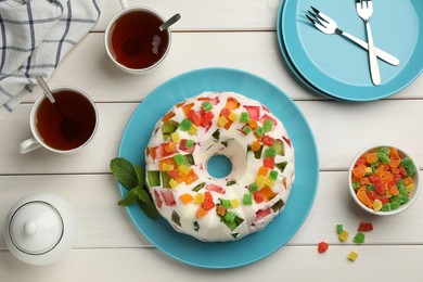 Photo of Delicious broken glass jelly cake on white wooden table, flat lay