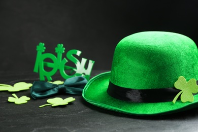 Photo of Leprechaun's hat and St. Patrick's day decor on black table