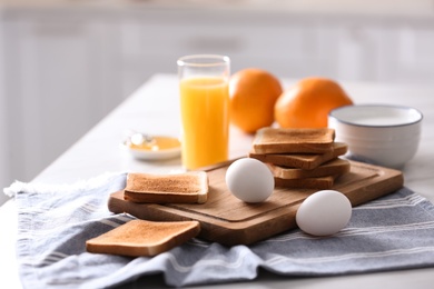 Photo of Delicious breakfast with toasts on table in kitchen