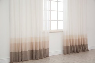 Photo of Modern window with curtains in room. Home interior