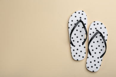 Photo of Stylish flip flops on beige background, flat lay. Space for text