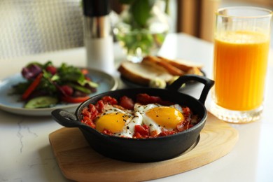 Photo of Tasty Shakshouka served on white table. Traditional Arabic dish