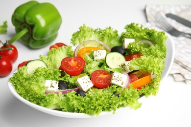 Photo of Tasty fresh Greek salad on white table, closeup