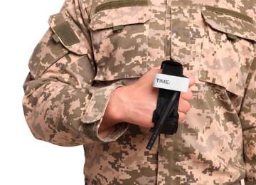 Photo of Soldier in military uniform holding medical tourniquet on white background, closeup