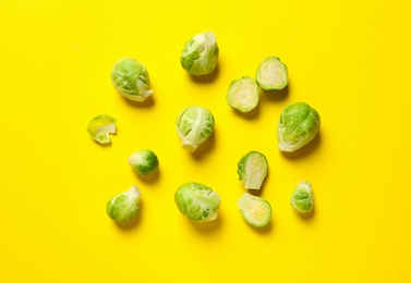 Photo of Fresh Brussels sprouts on color background, flat lay