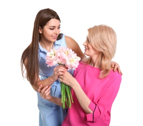 Photo of Young woman congratulating her mature mom on white background. Happy Mother's Day
