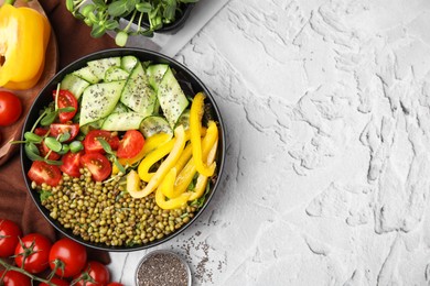 Photo of Bowl of salad with mung beans on white textured table, flat lay. Space for text