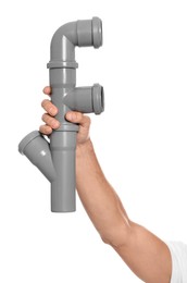 Photo of Male plumber holding pipe fitting on white background, closeup