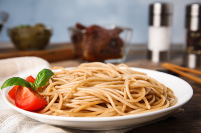 Photo of Tasty buckwheat noodles served on wooden table