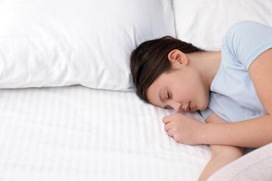 Photo of Cute little girl sleeping in bed. Space for text