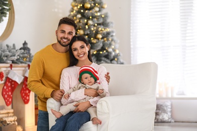 Happy family with cute baby at home. Christmas celebration