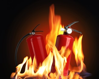 Image of Fire extinguishers surrounded by flame on dark background