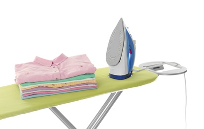 Photo of Board with modern iron and clean laundry on white background