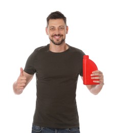 Photo of Man holding red container of motor oil and showing thumbs up on white background