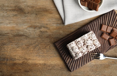 Photo of Flat lay composition with tiramisu cake on wooden table, space for text