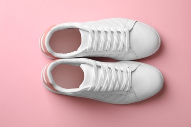 Photo of Pair of sneakers on color background, flat lay