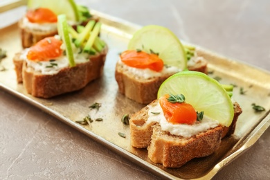 Photo of Sandwiches with fresh sliced salmon fillet and avocado on tray