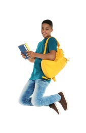 Photo of African-American teenager boy with books on white background