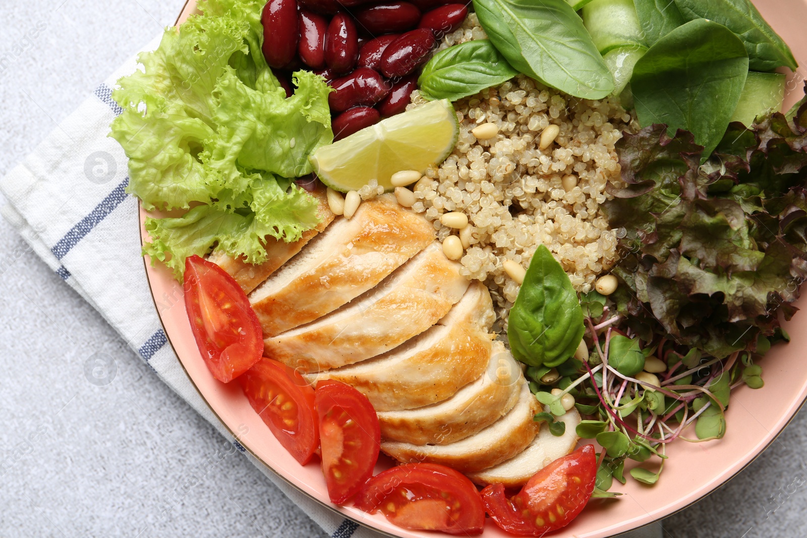 Photo of Healthy meal. Tasty vegetables, quinoa and chicken breast in bowl on white table, top view