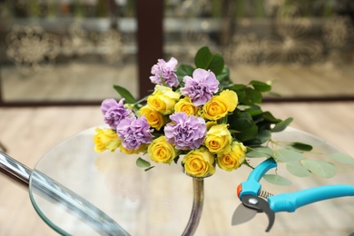 Photo of Beautiful bouquet on table in flower shop. Florist's workplace