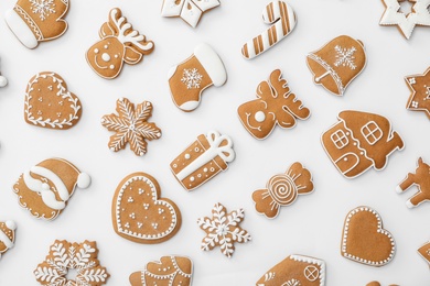 Photo of Different Christmas gingerbread cookies on white background, top view