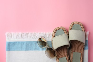 Photo of Flat lay composition with beach accessories on pink background, space for text