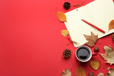Photo of Flat lay composition with cup of hot drink on red background, space for text. Cozy autumn atmosphere