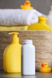 Photo of Baby cosmetic products and rubber duck on grey table