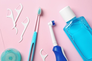 Photo of Flat lay composition with toothbrushes and oral hygiene products on color background