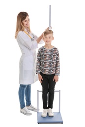 Photo of Doctor measuring little boy's height on white background