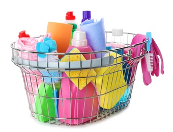 Metal shopping basket with different household chemicals on white background