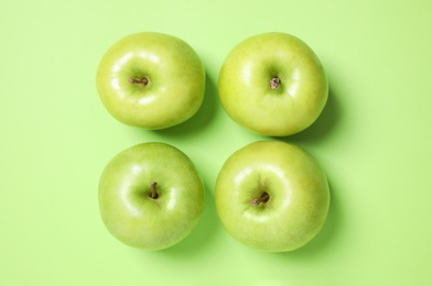 Photo of Fresh ripe apples on green background, flat lay