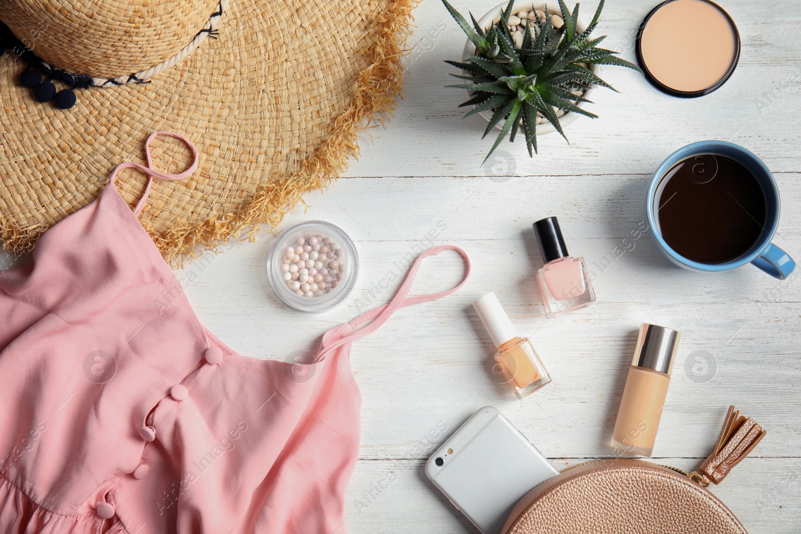 Photo of Flat lay composition with stylish clothes and cosmetics on wooden table. Beauty blogger