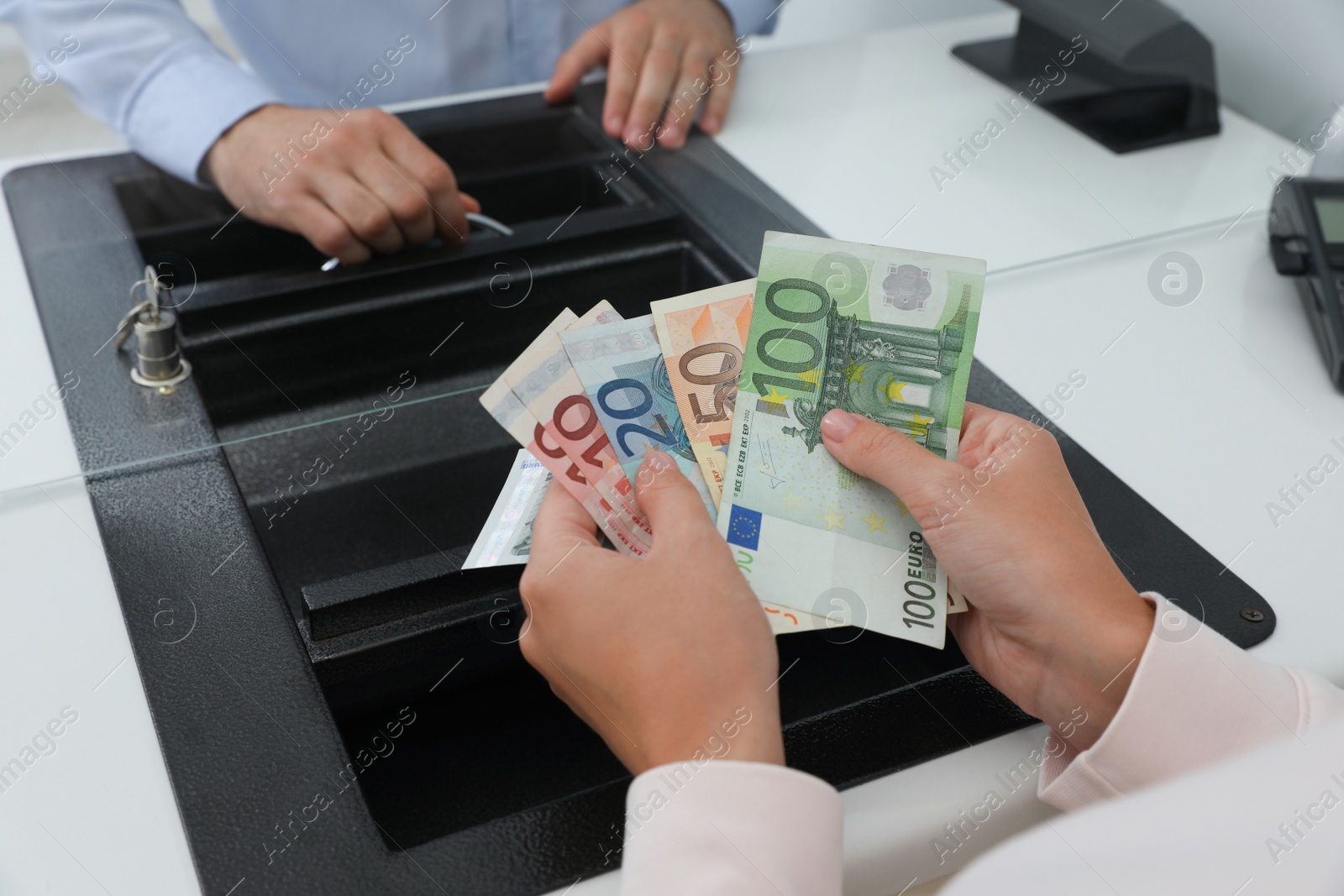 Photo of Woman with money at currency department window in bank, closeup