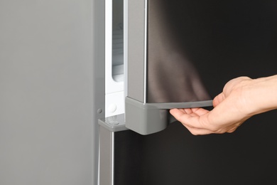 Photo of Woman opening refrigerator door, closeup. Space for text