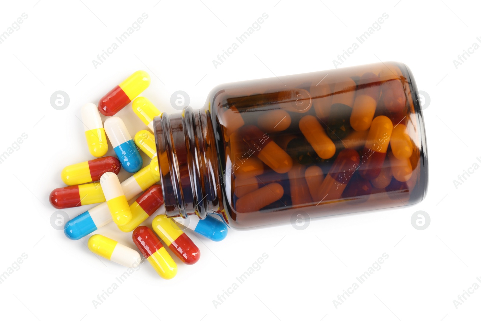 Photo of Antibiotic pills and bottle isolated on white, top view