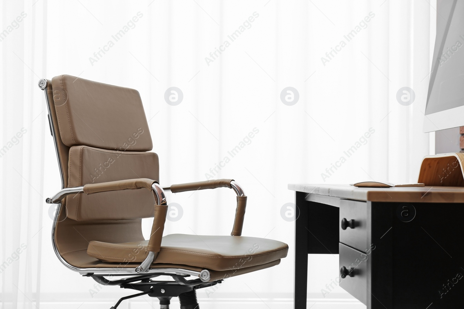 Photo of Modern office chair in stylish workplace interior