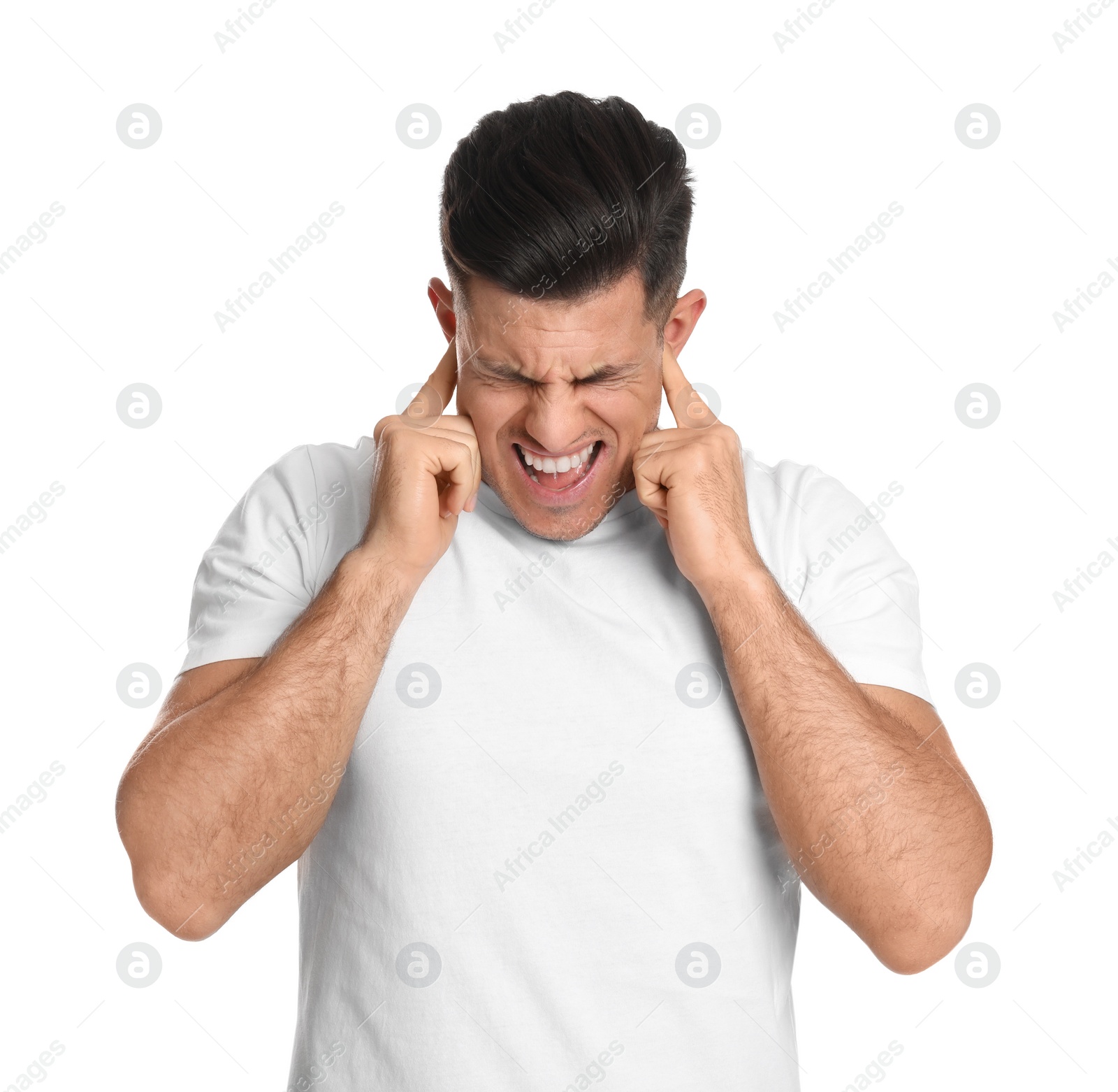 Photo of Emotional man covering ears with fingers on white background