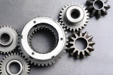 Photo of Different stainless steel gears on grey background, flat lay