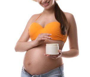 Photo of Young pregnant woman with sun protection cream on white background, closeup
