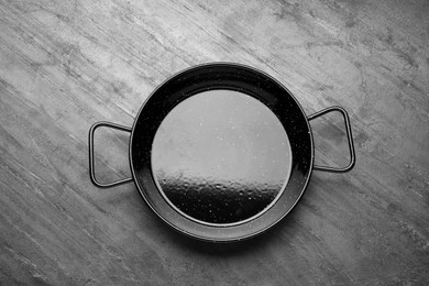 Photo of New stir-fry pan on grey table, top view