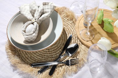 Photo of Easter table setting with bunny ears made of egg and napkin, above view