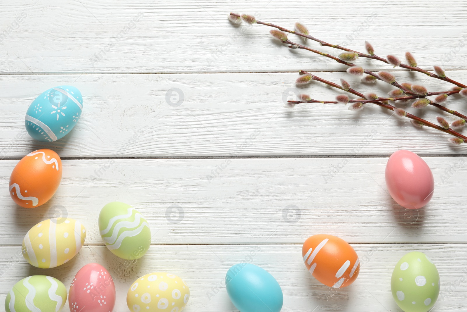 Photo of Flat lay composition with painted Easter eggs on wooden background, space for text