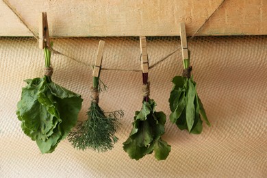 Photo of Bunches of different herbs on rope indoors