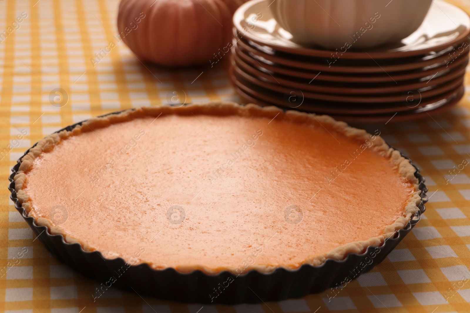 Photo of Delicious homemade pumpkin pie in baking dish on table