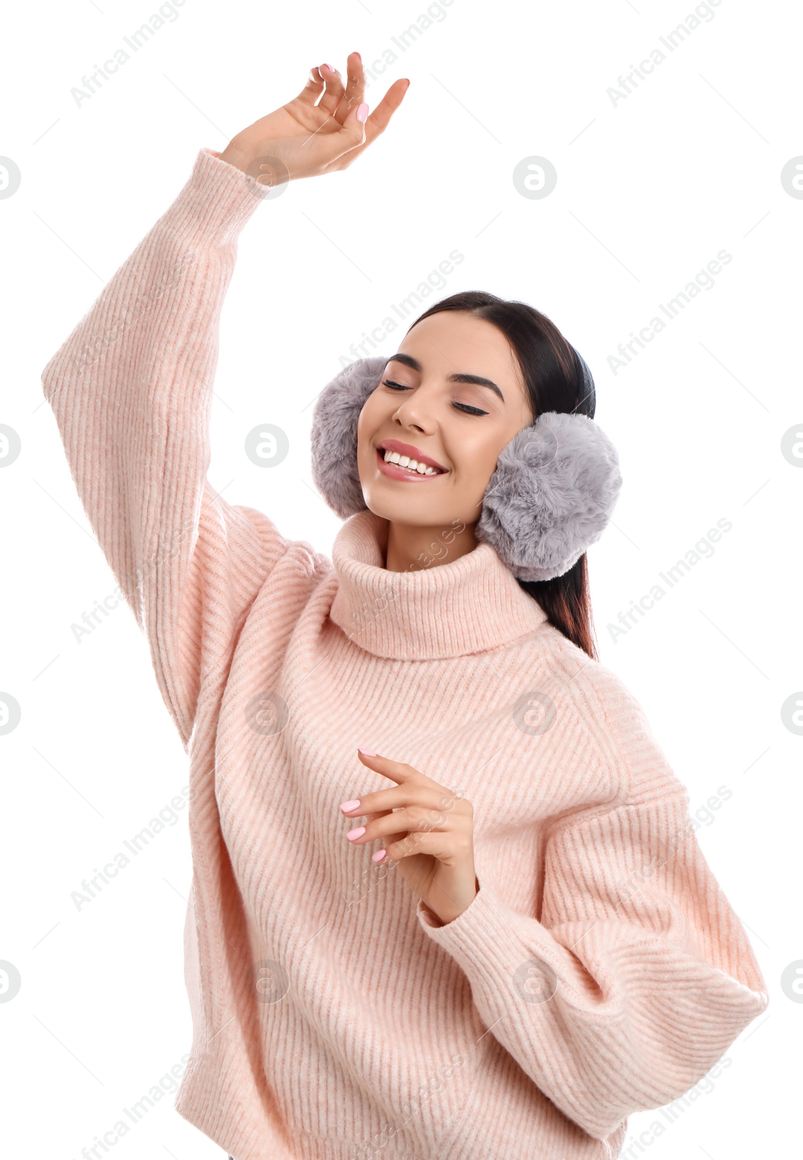 Photo of Beautiful young woman wearing earmuffs on white background