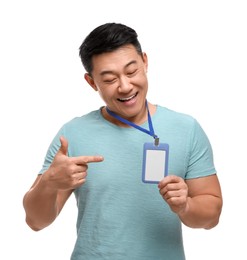 Happy asian man pointing at vip pass badge on white background