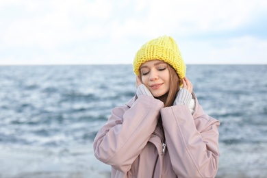 Portrait of beautiful young woman near sea