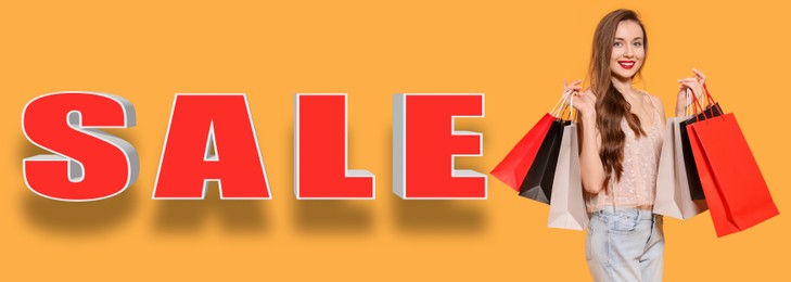Beautiful young woman with paper shopping bags and word Sale on orange background, banner design